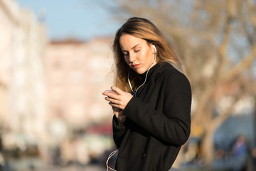 Beautiful girl listening to the music with earphones