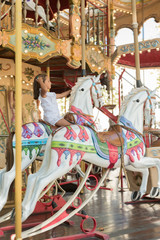 Little girl enjoying in a nice carousel © acongar