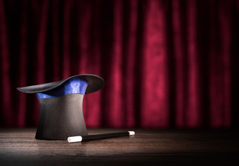 high contrast image of magician hat and wand on stage