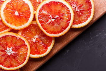 Blood orange cut in circles on a dark background