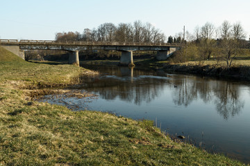 Fototapeta na wymiar River with a bridge in the backround in Sabile, Latvia