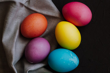 Obraz na płótnie Canvas Colored easter eggs on a black background