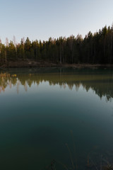 Fototapeta na wymiar Beautiful turquoise lake in Latvia - Meditirenian style colors in Baltic states - Lackroga ezers