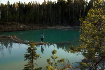 Fototapeta na wymiar Beautiful turquoise lake in Latvia - Meditirenian style colors in Baltic states - Lackroga ezers