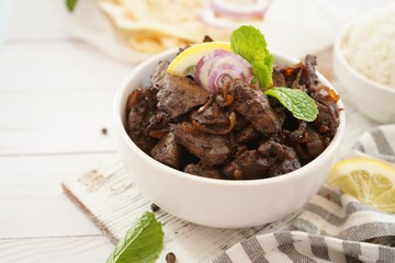 Beef Liver fry or roast served with rice and Roti, selective focus