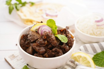Beef Liver fry or roast served with rice and Roti, selective focus