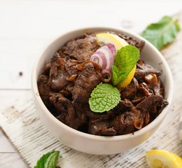 Beef Liver fry or roast served with rice and Roti, selective focus