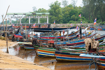 Fototapeta na wymiar The fishing boats parked at the harbor
