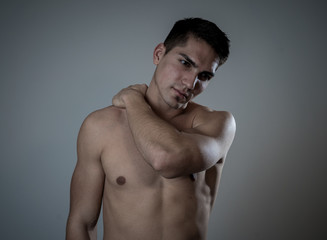 Fototapeta premium Strong young man suffering neck and cervical pain
