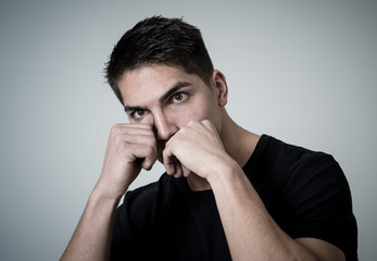 Young attractive man with an angry face in boxing stance ready to fight