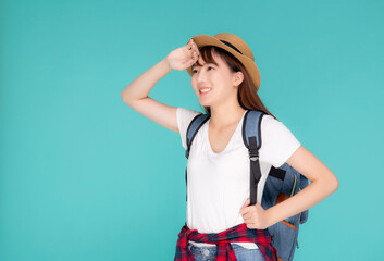 Fototapeta premium Beautiful portrait young asian woman wear hat on head smile expression confident enjoy summer trip holiday isolated blue background, model girl fashion having backpack, travel concept.