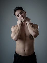 Fototapeta premium Strong young man suffering neck and cervical pain