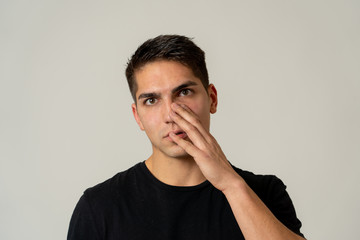 Attractive young man in his 20s suffering pain with headache and migraines.