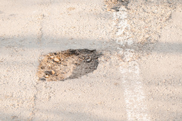 Holes on the road. dangerous pothole in the asphalt highway