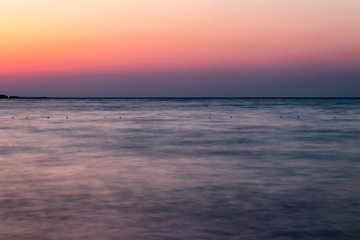 a long exposure wide landscape shoot of sea at sunset with good colors very smooth shoot