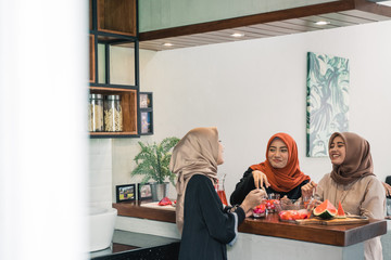 muslim woman quality time with friend having fruit cocktail for break fasting in ramadan together