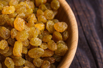 golden raisins on a wooden rustic background