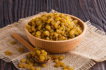 golden raisins on a wooden rustic background