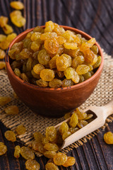 golden raisins on a wooden rustic background