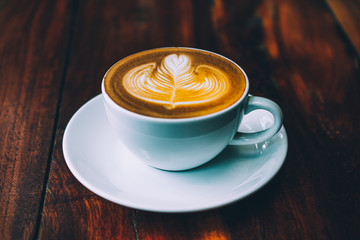 People are drinking a latte in a coffee shop.