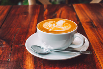 People are drinking a latte in a coffee shop.