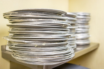 Greased pizza pans in a restaurant kitchen