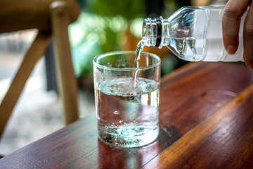 People pouring water into the glass