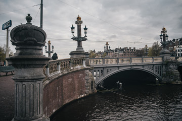 Ancient bridge in Amsterdam with cityscape