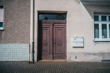 Old typical european facade with old styled wooden doors