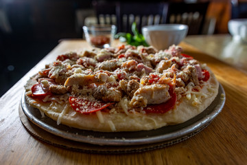Pizza with ingredients on a cutting board