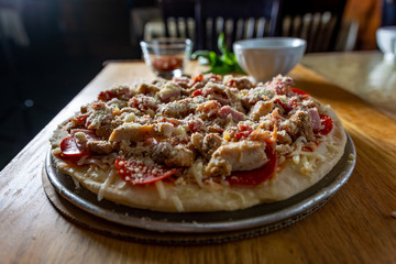 Pizza with ingredients on a cutting board