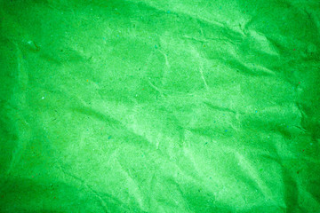 Green vignette crumpled paper.