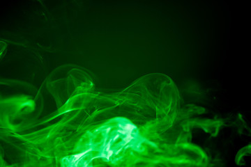 Green smoke motion on black background.