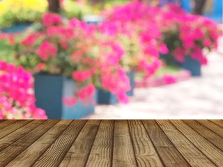 Products shelves and advertisements are wooden floors. Pink flower background (blurred image)