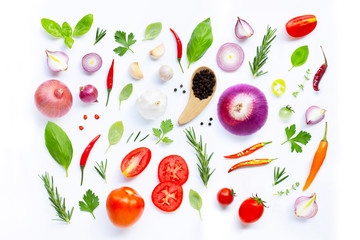 Various fresh vegetables and herbs on white background.