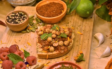 Hummus, raspberries and edible flowers on toast