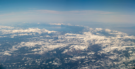 Fototapeta premium Wide Angle View of Large Lake Surrounded by Snowed Peak Mountains