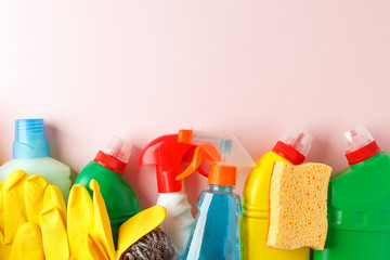 Colorful cleaning set for different surfaces in kitchen, bathroom, other rooms. Copy space for text or logo on pink background. Cleaning service concept. Early spring regular clean up