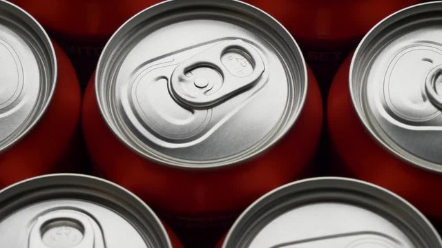 top view on red can of soda or beer rotate background. Slow motion video dolly crane shot medium extreme close up panorama high angle telephoto lens