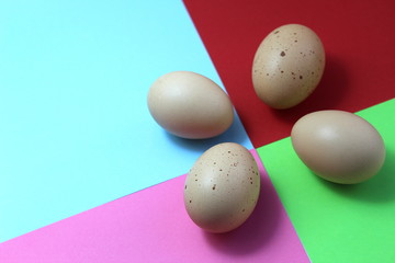 Chicken eggs lie on a bright colorful background