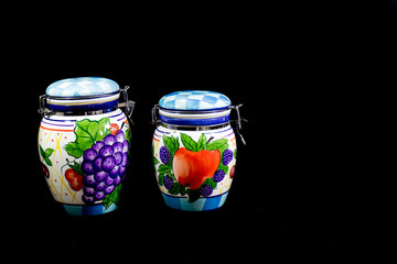 Two Kitchen Containers Against Black Background