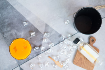 Closeup photo of a glass of fresh orange juice with ice cubes