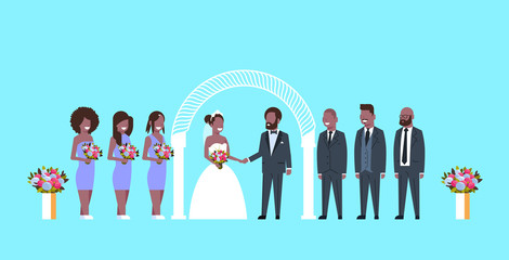 just married bride and groom with african american bridesmaids groomsmen standing together near arch wedding ceremony concept blue background full length horizontal flat