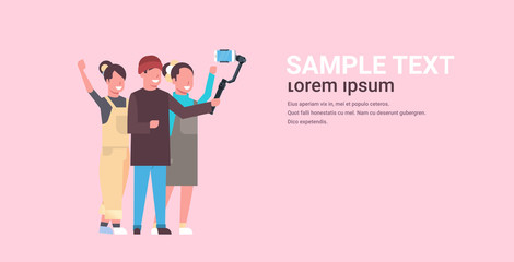 casual people using 3-axis gimbal stabilizer selfie stick for smartphone happy man and two women standing together taking photo on smart phone camera horizontal full length