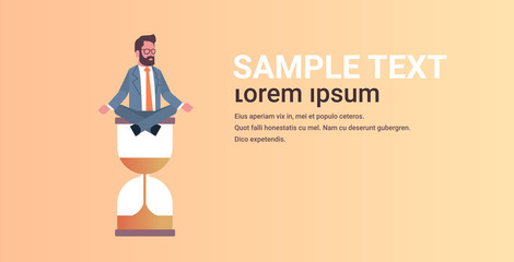 businessman sitting lotus position on sand clock time management deadline concept business man meditating in yoga pose horizontal male character full length copy space