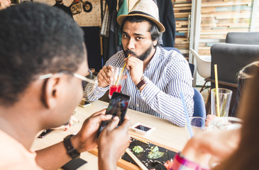 Meet young attractive people in the cafe. Friends chat, have fun, drink cocktails and eat