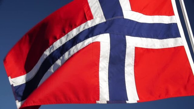 A Norwegian flag waving in the wind.
