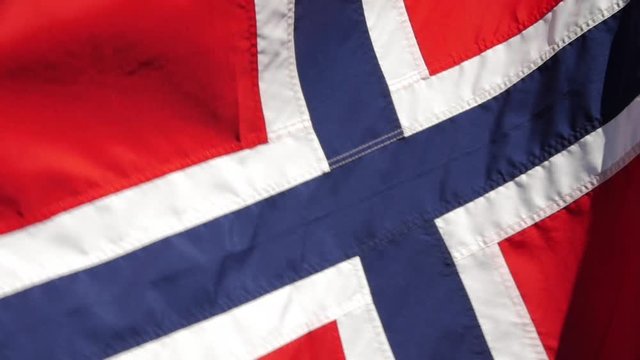 A Norwegian flag waving in the wind.