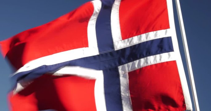 A Norwegian flag waving in the wind.
