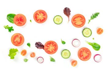 Fresh vegetable salad ingredients, shot from the top on a white background. A flat lay composition with tomato, cucumber, onion slices and mezclun leaves, forming a frame with copy space